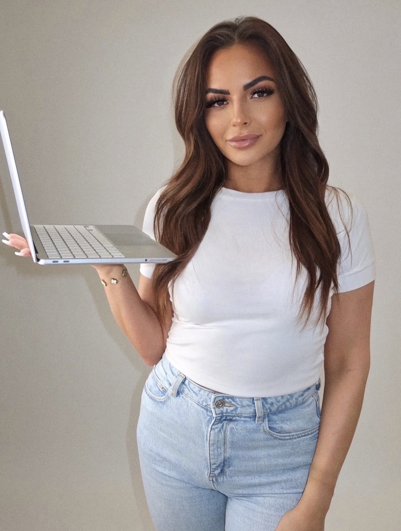 Heidi-Marie, founder of MUSE Collective, holding a laptop